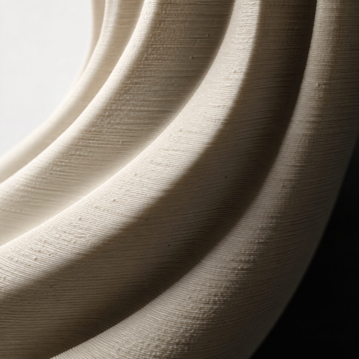 Macro detail of curved 3D-print layer lines and surface texture